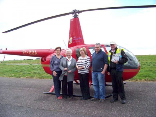 Pictured at Cork Airport with daughters Noreen and Geraldine and son, John D. - Eily Buckley together with the pilot was absolutely thrilled with her helicopter trip 80th birthday surprise.  (S.R.)