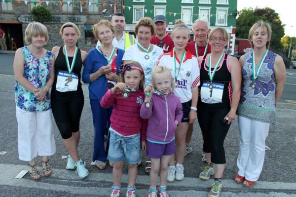 The spectacular highlight of Day 2 was the enormously successful Willie Neenan Road Race.  Here we view the winning lady champion - Martina Kiely (nee Hickey) receiving her prizes from Marie Neenan & Fr. Paddy O'Byrne while we also meet the Neenan Family including John D. who travelled from USA to coincide with the historic race.  (S.R.)