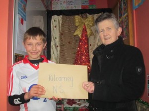 2013-12-17 Kilcorney N.S. Pupil Evan Murphy presenting Angela Bourke (St.Vincent de Paul) with their donations from their Christmas Nativity