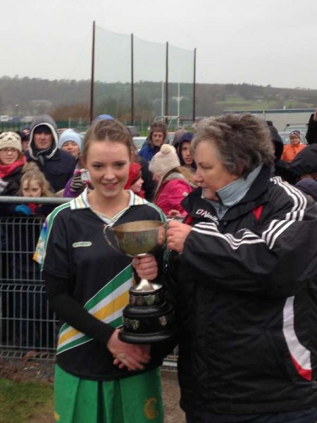 Having become County Champions Captain Leanne Kelleher accepts the winning Cup while Lydia O'Reilly accepts her award as Player of the Match.  The dedicated Trainers are  Anthony Barry, Lilly Murphy, and Tony McCaul.   We thank Tony McCaul for the pictures and the information.  Click on the images to enlarge.  (S.R.) 