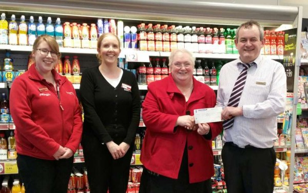 Following the pre-Christmas 2014 Fundraising Staff Jumper Day Manager of Supervalu Joe Fitzgerald presents a cheque to Matron Lena Kelleher for Millstreet Community Hospital.  We thank Rachel for the photograph.  Click on the image to enlarge.  (S.R.)